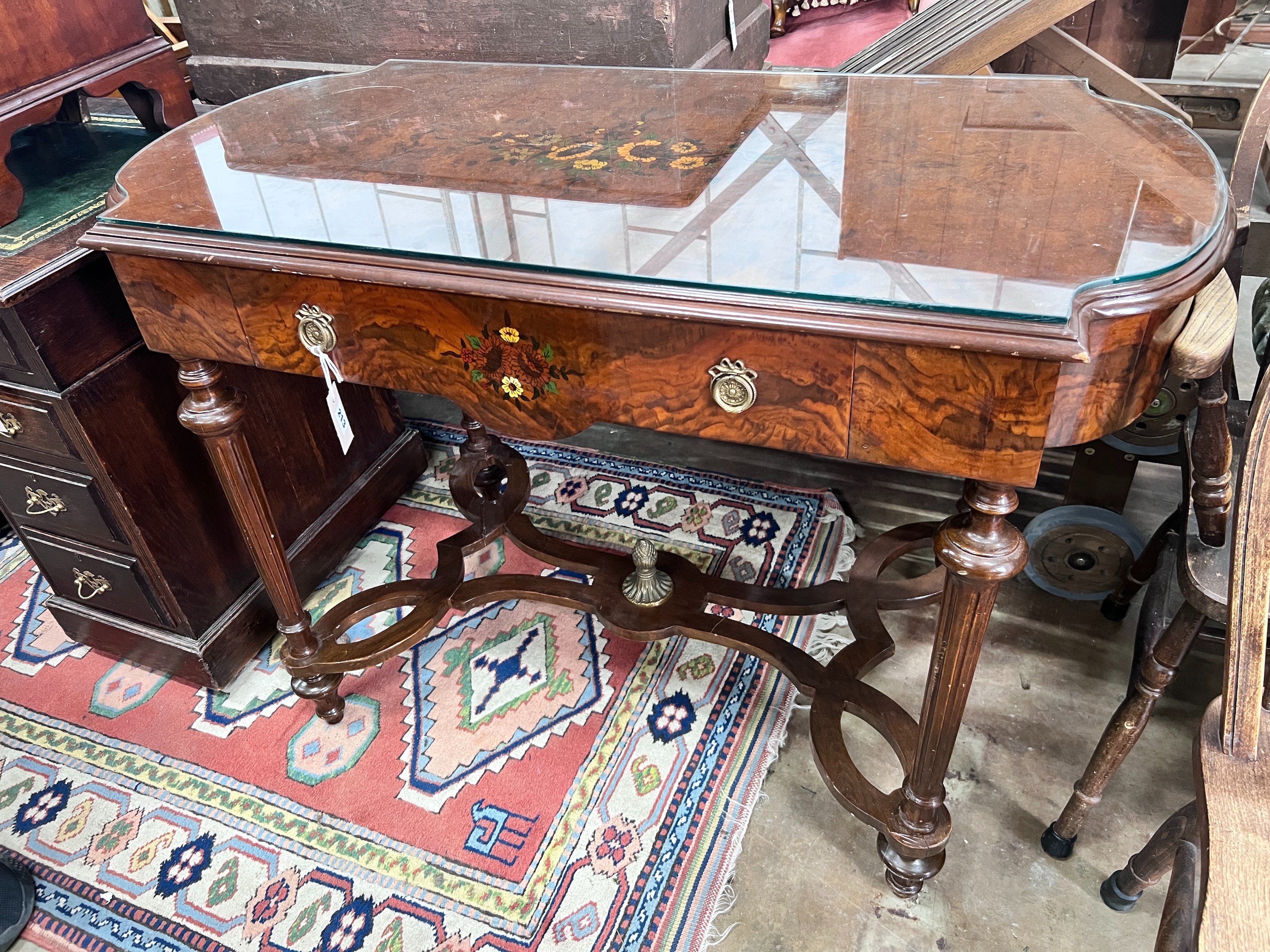 A continental marquetry inlaid walnut centre table, 117 x 59cm *Please note the sale commences at 9am.